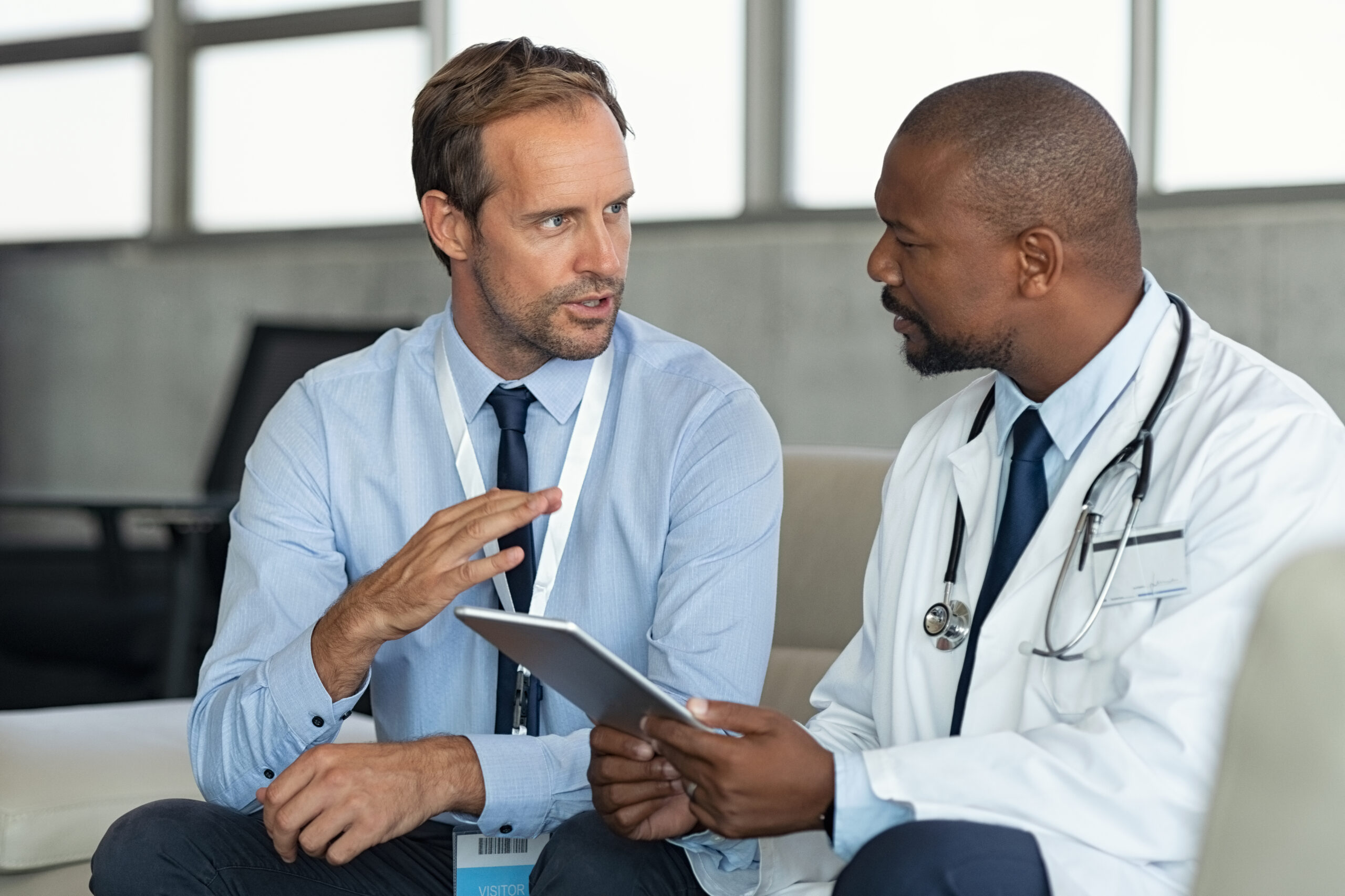 Doctor in conversation with pharmaceutical representative