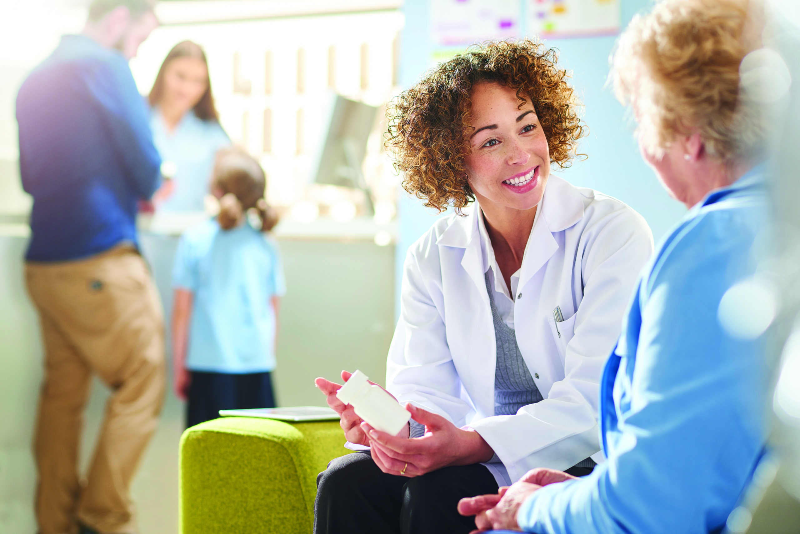 Doctor showcasing medical device to patient